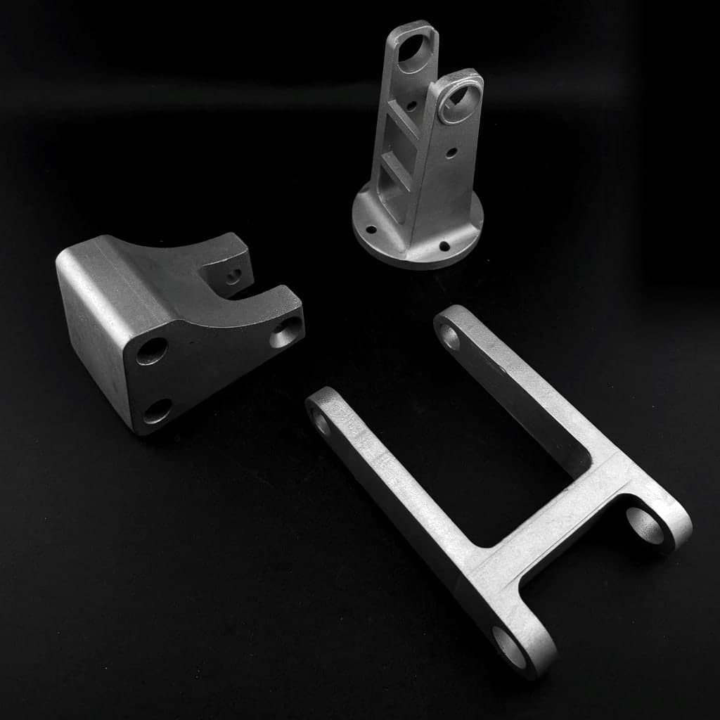 Cast aluminum brackets and a clevis mount made for Genie Mobility